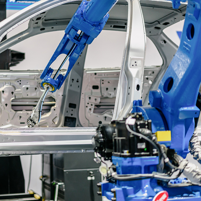 robot arm in factory working on car