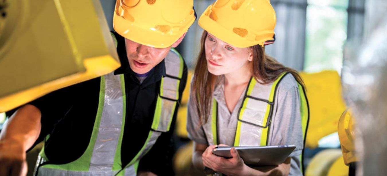 Engineers inspecting manufacturing equipment