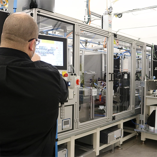 Employee touching screen for hydrogen fuel cell production line equipment