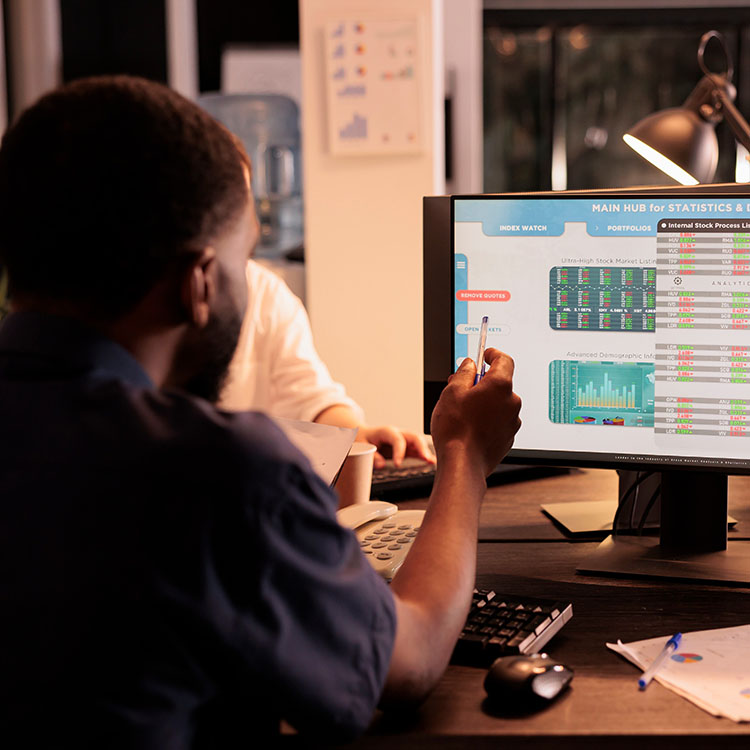 Employee analyzing data statistics on computer